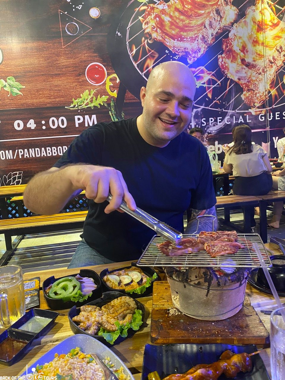 where do the locals eat in ho chi minh city as Fredrick grills up bbq at a local bbq restaurant